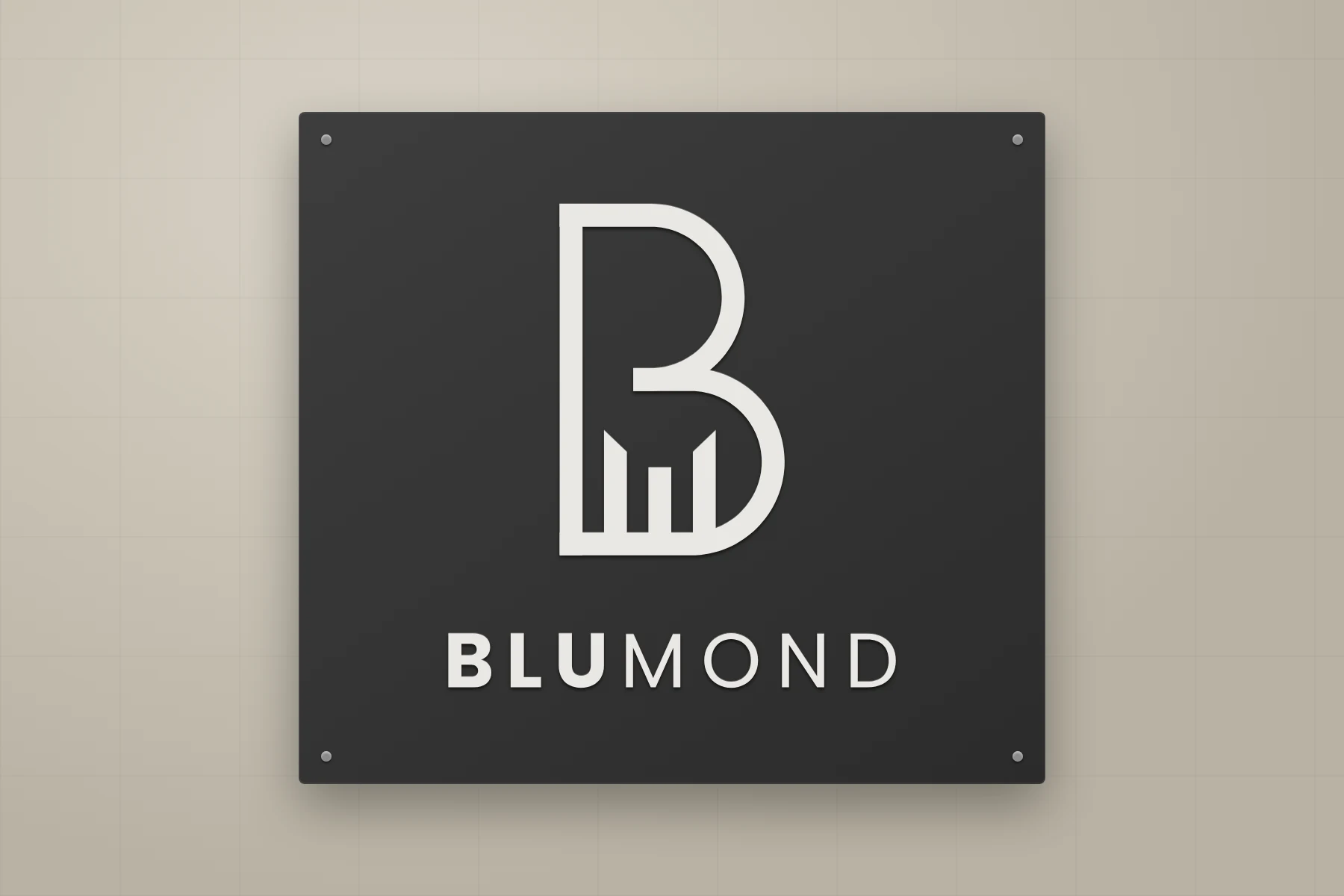 Click to view full size Blumond logo as a wall-mounted plaque with raised off-white lettering on charcoal