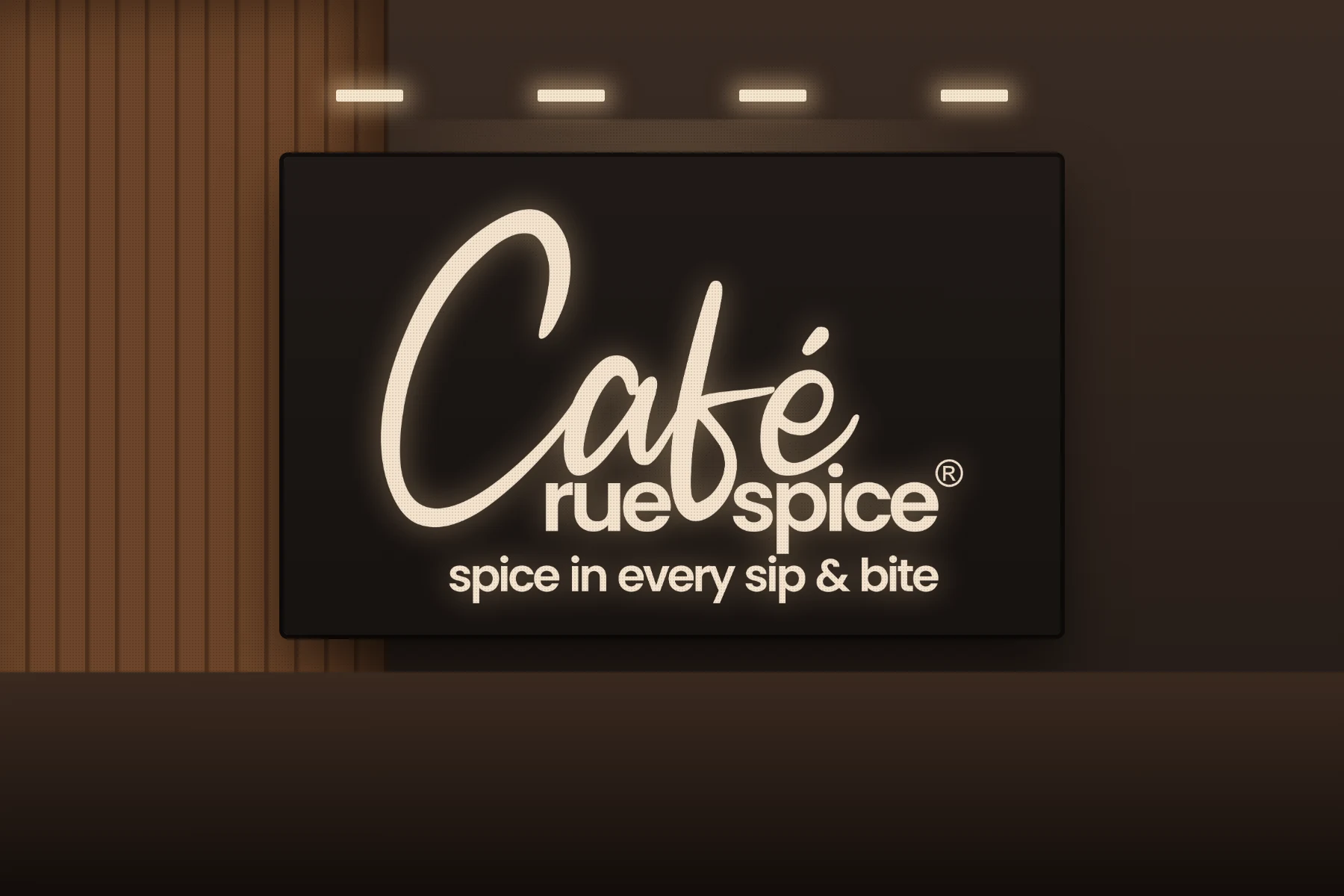 Click to view full size Cafe Rue Spice logo as a backlit sign on a dark feature wall